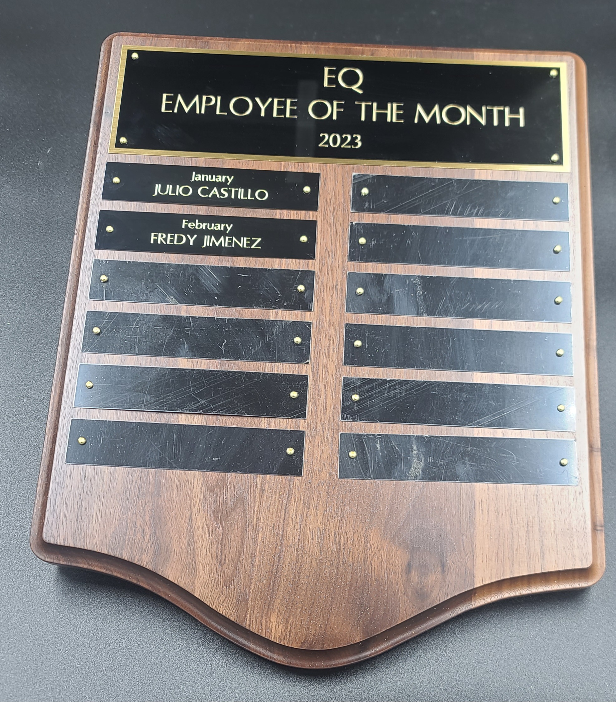 Walnut perpetual plaque with black and gold employee of the month plates for monthly recipients