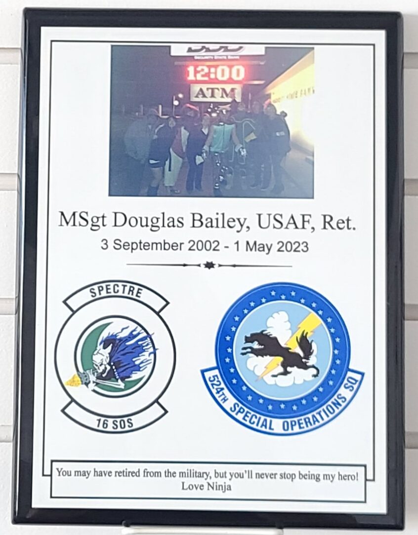 Framed military retirement plaque with photo, USAF squadron patches, and personalized tribute for retiring master sergeant