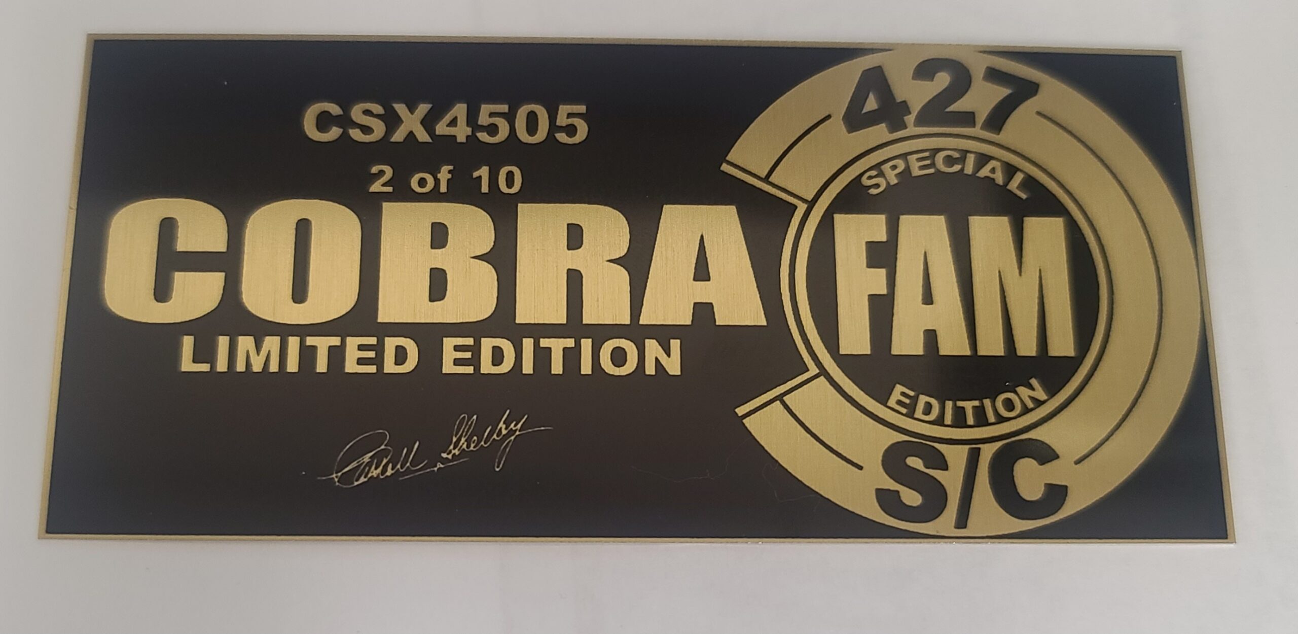 Black and gold laser-engraved metal plaque for Shelby Cobra 427 limited edition numbered collectible