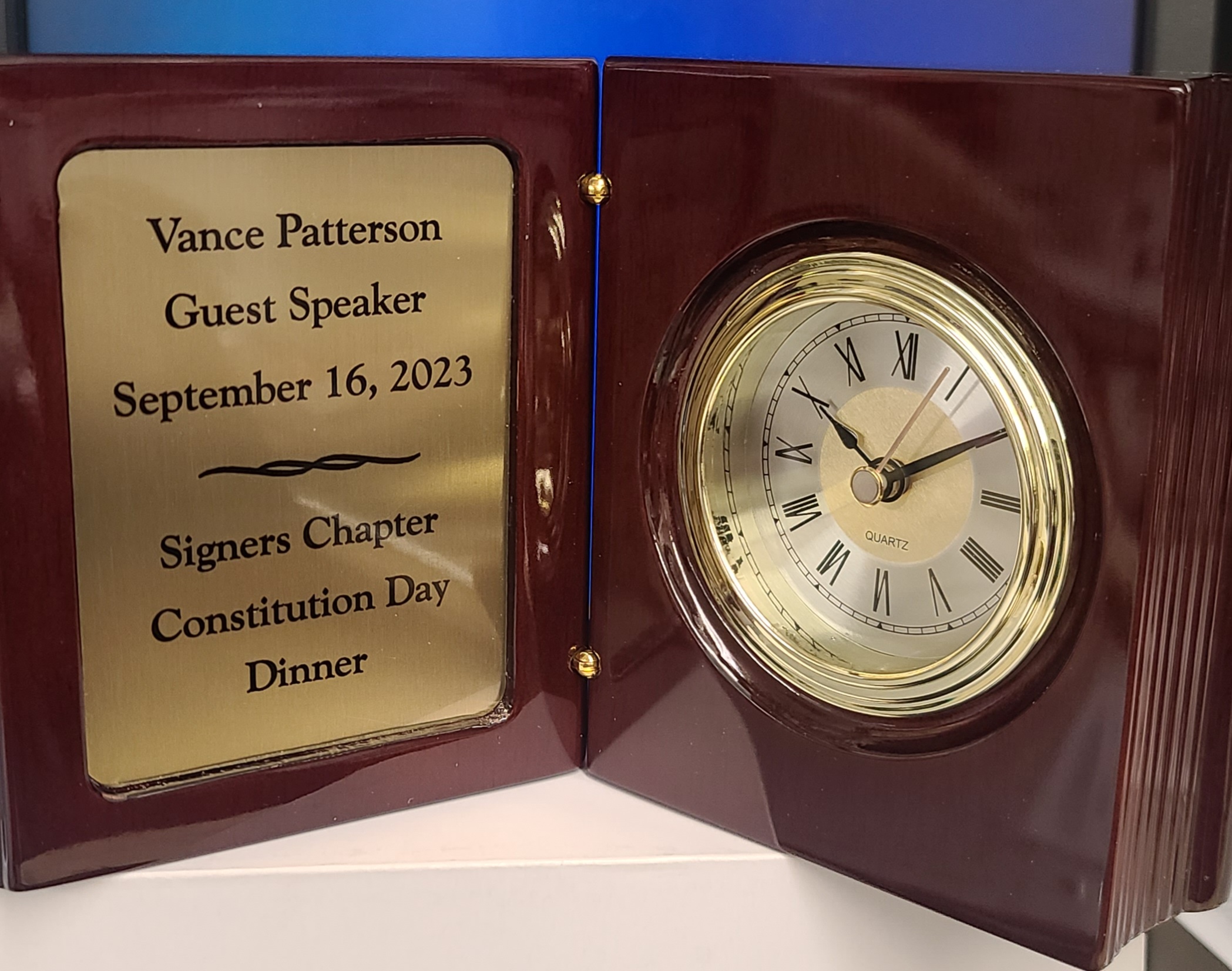 Rosewood book-style award with gold engraved plate and brass quartz clock for guest speaker recognition