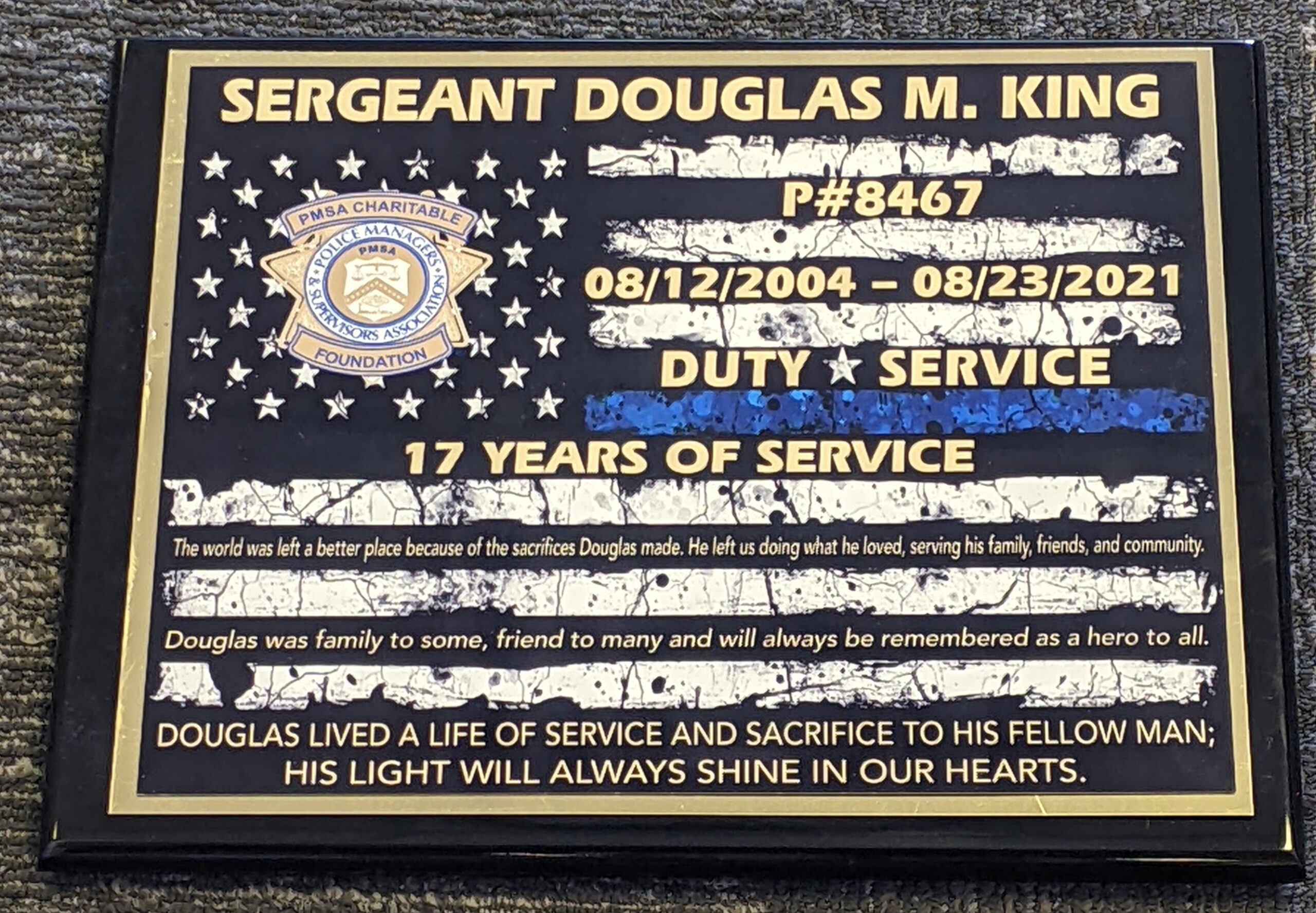 Black and gold law enforcement memorial plaque with thin blue line flag design honoring 17 years of police service