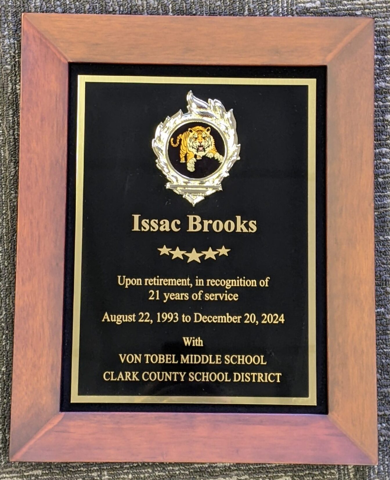 Walnut framed black plaque with gold engraving and tiger mascot medallion honoring 21 years of service