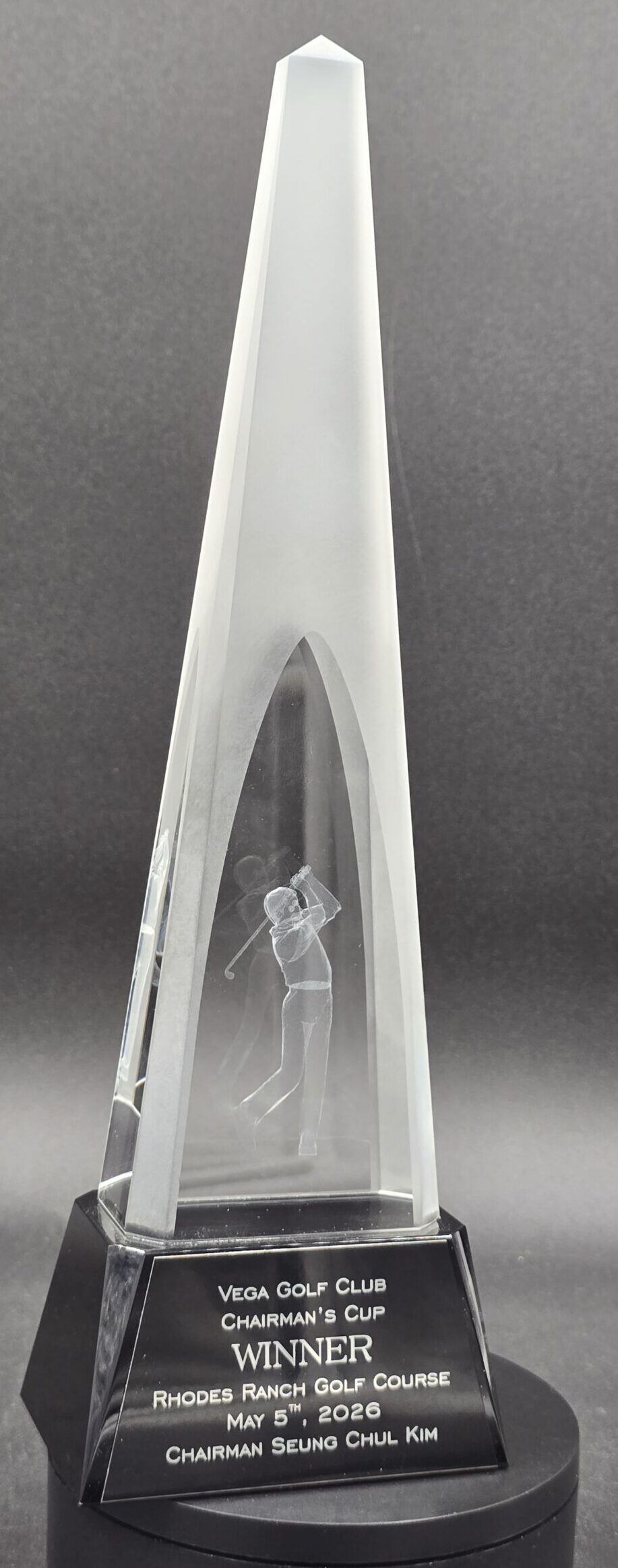 Tall crystal obelisk award with 3D laser-engraved golfer figure and black engraved base for golf tournament winner