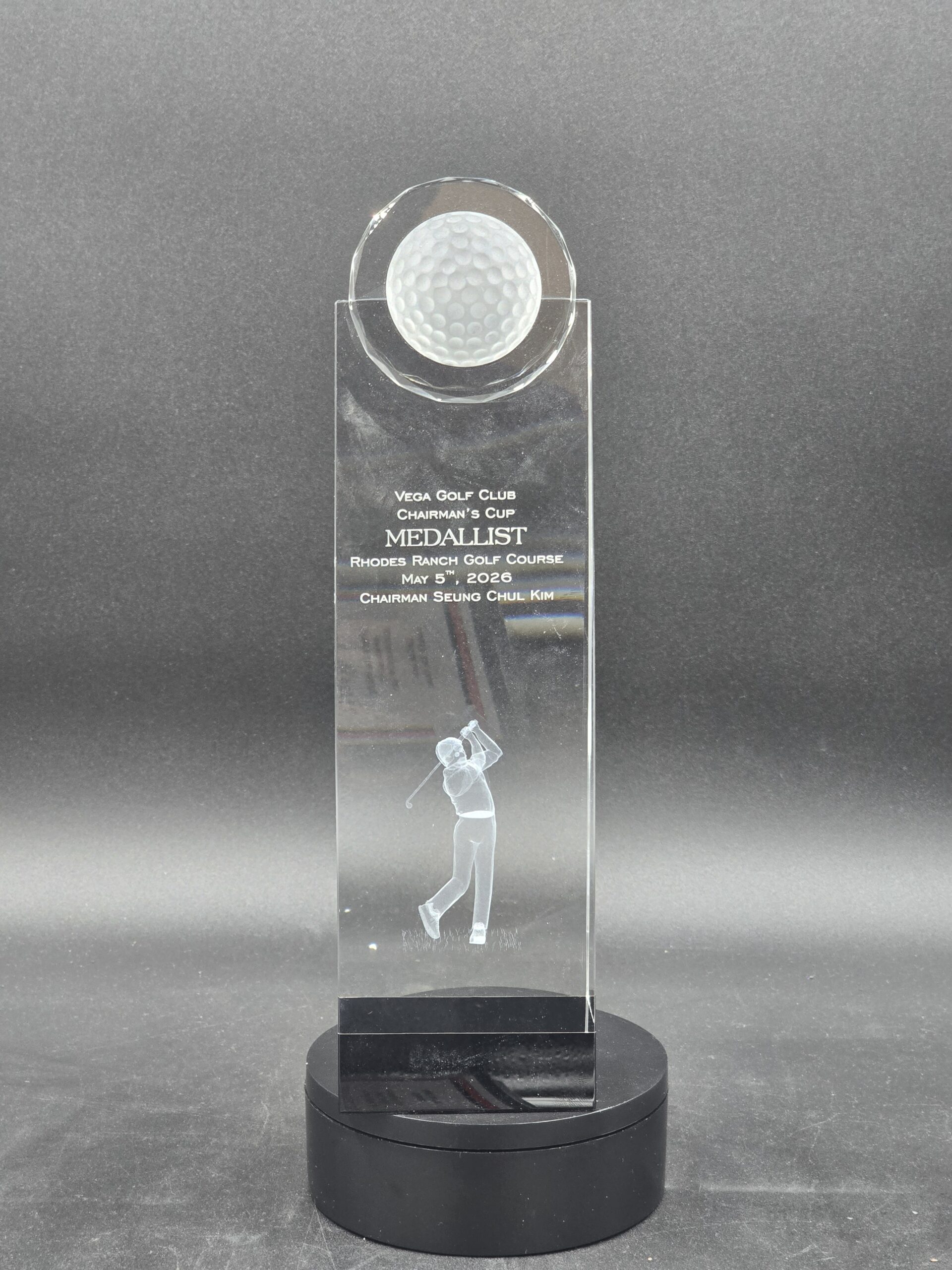 Crystal golf award with embedded golf ball topper and 3D laser-engraved golfer figure on black round base