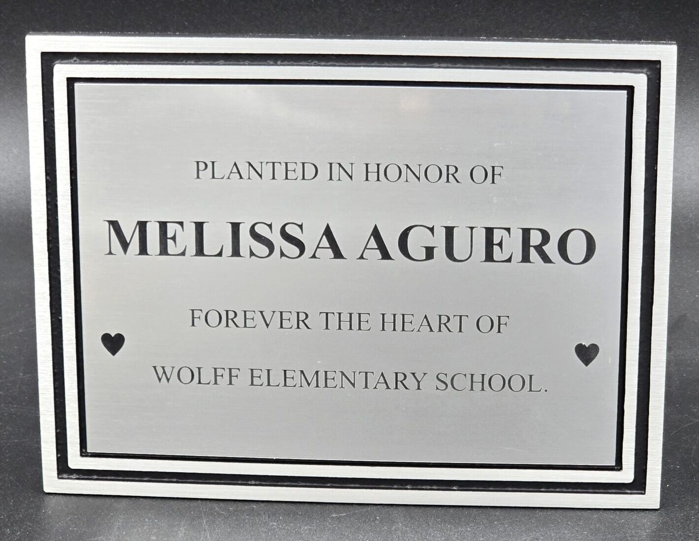 Brushed silver aluminum dedication plaque with black border frame laser-engraved for memorial tree planting at school, Las Vegas