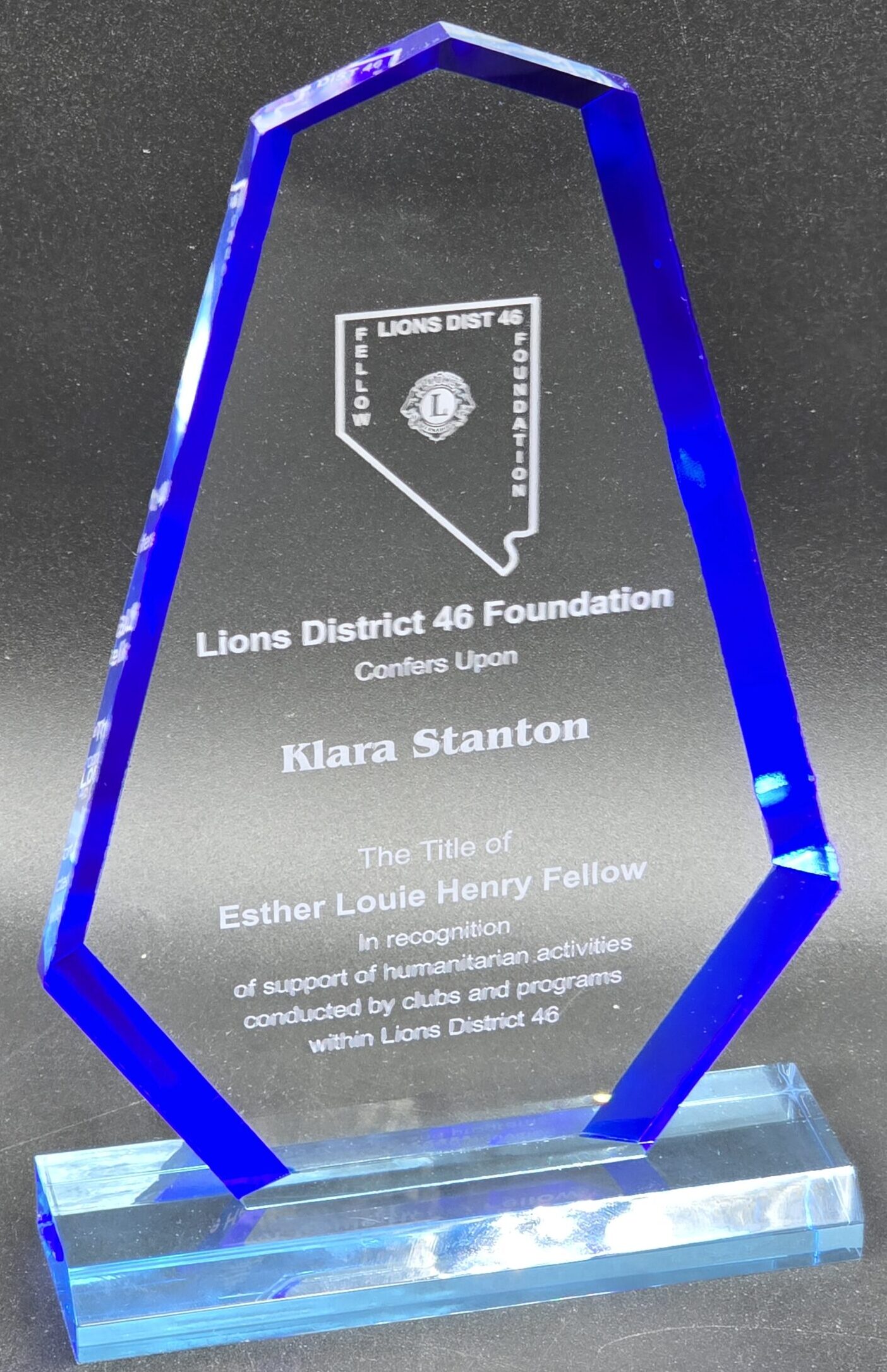 Clear crystal award with blue beveled edges and laser-engraved Nevada state outline and Lions Club recognition text