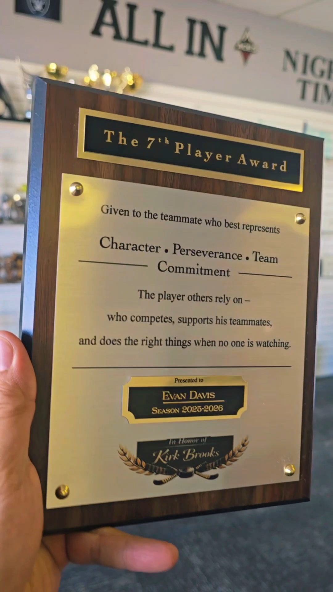 Walnut plaque with gold engraved plate honoring character, perseverance, and team commitment for the 7th Player Award