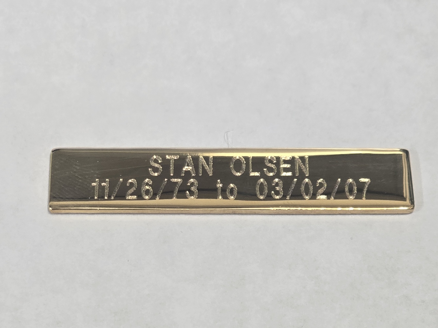 Custom gold bar shaped award with laser-engraved text, Las Vegas trophy shop
